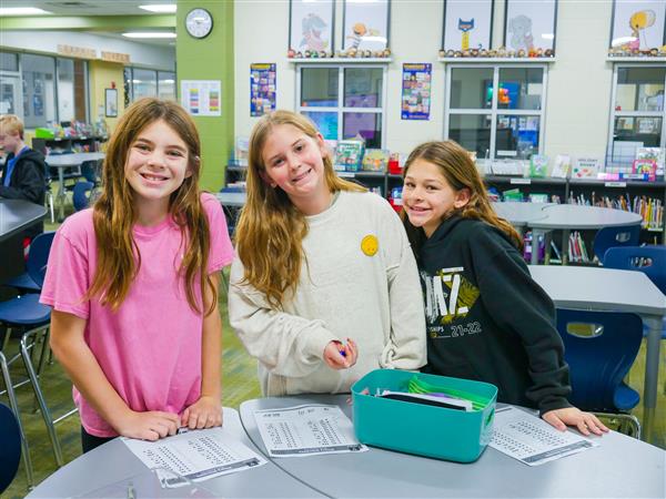 three girls in library
